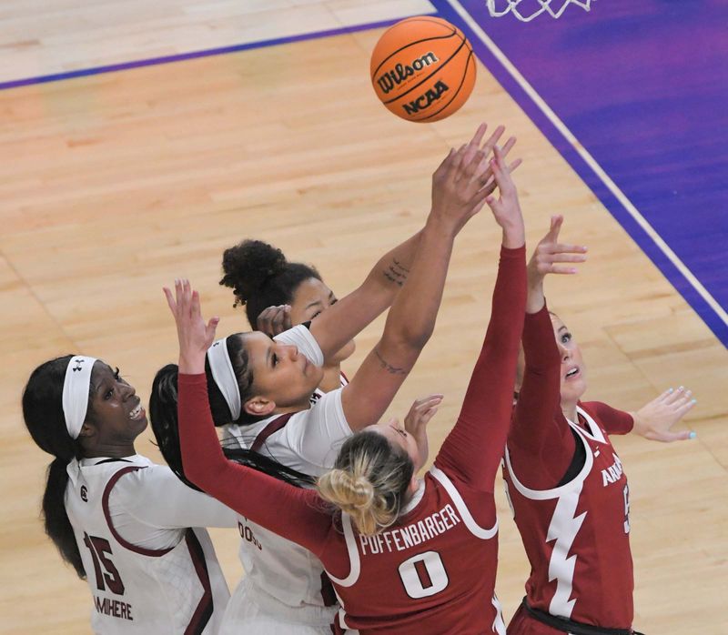 Mar 3, 2023; Greenville, SC, USA; South Carolina center Kamilla Cardoso (10) reaches for a rebound near Arkansas guard Saylor Poffenbarger (0) and Arkansas forward Emrie Ellis (55) during the first quarter at Bon Secours Wellness Arena. Mandatory Credit: Ken Ruinard-USA TODAY Sports