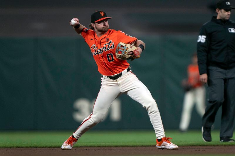 Sep 13, 2024; San Francisco, California, USA;  San Francisco Giants shortstop Brett Wisely (0) throws the ball during the eighth inning against the San Diego Padres at Oracle Park. Mandatory Credit: Stan Szeto-Imagn Images