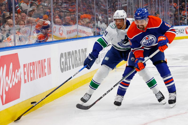 May 18, 2024; Edmonton, Alberta, CAN; Edmonton Oilers defensemen Cody Ceci (5) and Vancouver Canucks forward Dakota Joshua (81) battle along the boards for a loose puck during the second period in game six of the second round of the 2024 Stanley Cup Playoffs at Rogers Place. Mandatory Credit: Perry Nelson-USA TODAY Sports