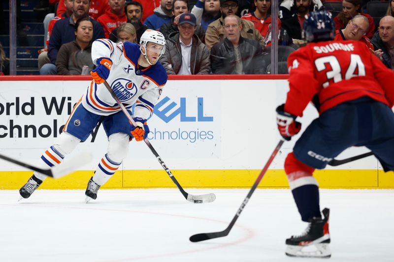 Nov 19, 2025; Washington, District of Columbia, USA; Edmonton Oilers center Connor McDavid (97) skates with the puck as Washington Capitals right wing Justin Sourdif (34) defends during the second period at Capital One Arena. Mandatory Credit: Geoff Burke-Imagn Images