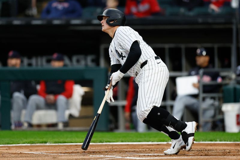 May 9, 2024; Chicago, Illinois, USA; Chicago White Sox first baseman Andrew Vaughn (25) hits an RBI-double against the Cleveland Guardians during the first inning at Guaranteed Rate Field. Mandatory Credit: Kamil Krzaczynski-USA TODAY Sports