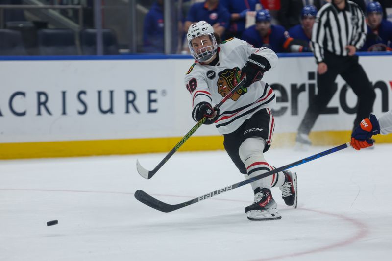 Apr 2, 2024; Elmont, New York, USA; Chicago Blackhawks center Connor Bedard (98) take a shot against the New York Islanders during the first period at UBS Arena. Mandatory Credit: Thomas Salus-USA TODAY Sports