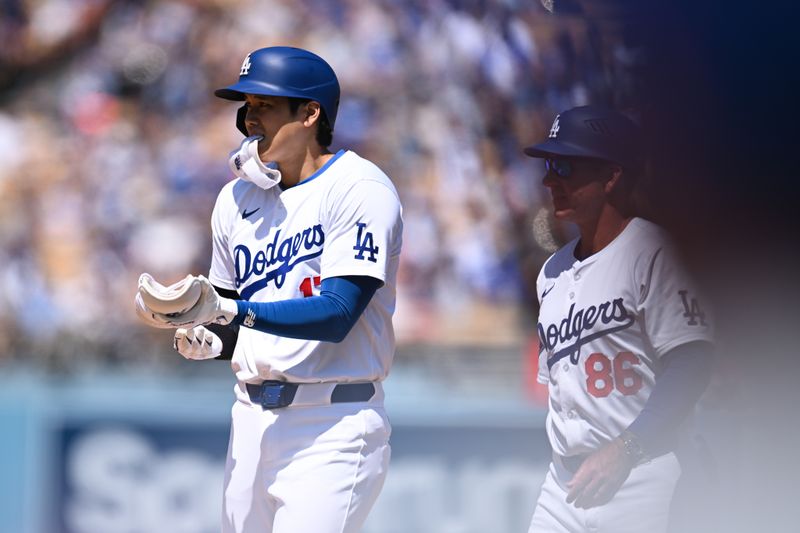 Apr 21, 2024; Los Angeles, California, USA; Los Angeles Dodgers designated hitter Shohei Ohtani (17) with first base coach Clayton McCullough (86) at first base against the New York Mets during the fifth inning at Dodger Stadium. Mandatory Credit: Jonathan Hui-USA TODAY Sports