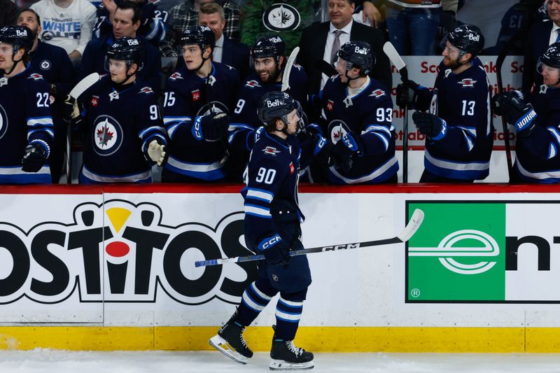 Apr 18, 2024; Winnipeg, Manitoba, CAN;  Winnipeg Jets forward Nikita Chibrikov (90) is congratulated by his team mates on his goal against the Vancouver Canucks during the third period at Canada Life Centre. Mandatory Credit: Terrence Lee-USA TODAY Sports