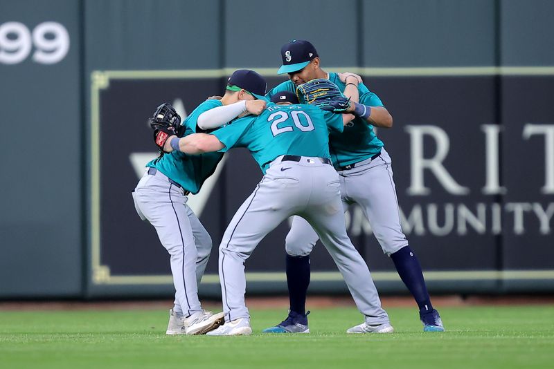 May 5, 2024; Houston, Texas, USA; Seattle Mariners outfielders celebrate after the final out against the Houston Astros during the ninth inning at Minute Maid Park. Mandatory Credit: Erik Williams-USA TODAY Sports