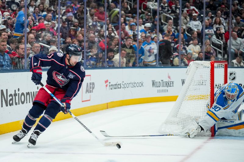 Nov 1, 2025; Columbus, Ohio, USA;  Columbus Blue Jackets left wing Miles Wood (11) skates with the puck against St. Louis Blues goaltender Joel Hofer (30) in the second period at Nationwide Arena. Mandatory Credit: Aaron Doster-Imagn Images