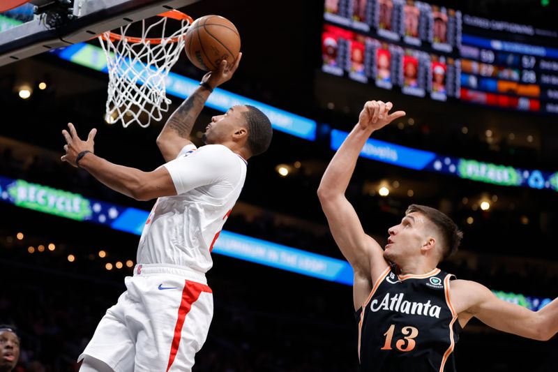 ATLANTA, GA - JANUARY 28: Norman Powell #24 of the LA Clippers goes to the basket over Bogdan Bogdanovic #13 of the Atlanta Hawks during the second half at State Farm Arena on January 28, 2023 in Atlanta, Georgia. NOTE TO USER: User expressly acknowledges and agrees that,  by downloading and or using this photograph,  User is consenting to the terms and conditions of the Getty Images License Agreement. (Photo by Alex Slitz/Getty Images)