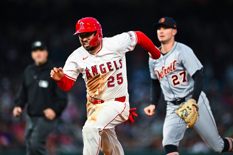 May 3, 2025; Anaheim, California, USA; Los Angeles Angels catcher Travis d'Arnaud (25) forced out at first base during a rundown against Detroit Tigers shortstop Trey Sweeney (27) during the fourth inning at Angel Stadium. Mandatory Credit: Jonathan Hui-Imagn Images