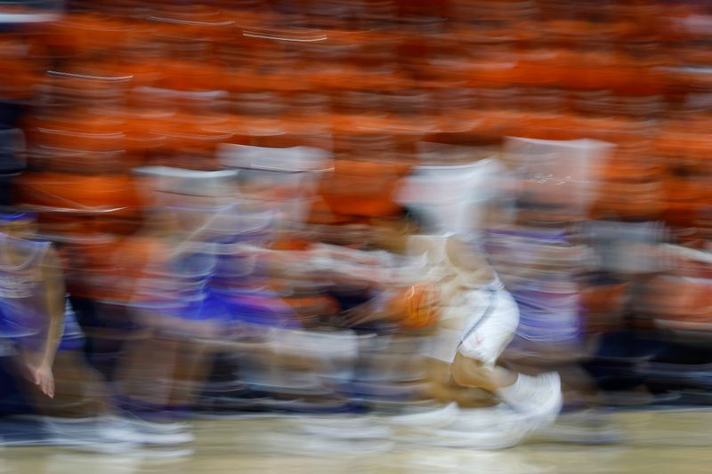 Feb 11, 2023; Charlottesville, Virginia, USA; Virginia Cavaliers guard Kihei Clark (0) dribbles the ball as Duke Blue Devils center Dereck Lively II (1) defends in the first half at John Paul Jones Arena. Mandatory Credit: Geoff Burke-USA TODAY Sports