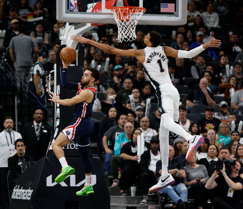 SAN ANTONIO, TX - JANUARY  29:  Victor Wembanyama #1 of the San Antonio Spurs forces Tyrus Jones #5 of the Washington Wizards to make a pass in the first half at Frost Bank Center on January 29, 2024 in San Antonio, Texas. NOTE TO USER: User expressly acknowledges and agrees that, by downloading and or using this photograph, User is consenting to terms and conditions of the Getty Images License Agreement. (Photo by Ronald Cortes/Getty Images)