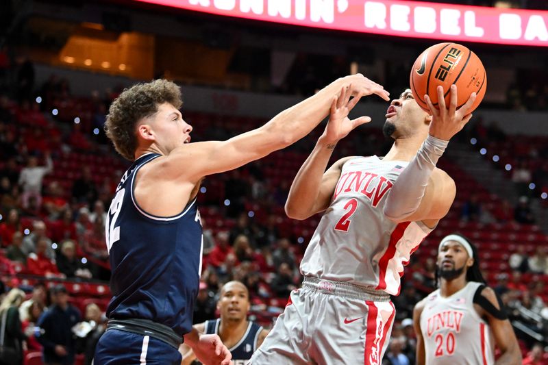 Jan 13, 2024; Las Vegas, Nevada, USA; UNLV Rebels guard Justin Webster (2) is fouled by Utah State Aggies guard Mason Falslev (12) in the first half at Thomas & Mack Center. Mandatory Credit: Candice Ward-USA TODAY Sports