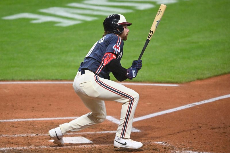 May 9, 2025; Cleveland, Ohio, USA; Cleveland Guardians second baseman Daniel Schneemann (10) singles in the fifth inning against the Philadelphia Phillies at Progressive Field. Mandatory Credit: David Richard-Imagn Images
