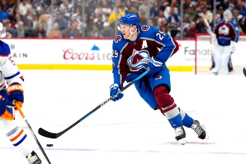 Apr 18, 2024; Denver, Colorado, USA; Colorado Avalanche center Nathan MacKinnon (29) controls the puck in the second period against the Edmonton Oilers at Ball Arena. Mandatory Credit: Ron Chenoy-USA TODAY Sports