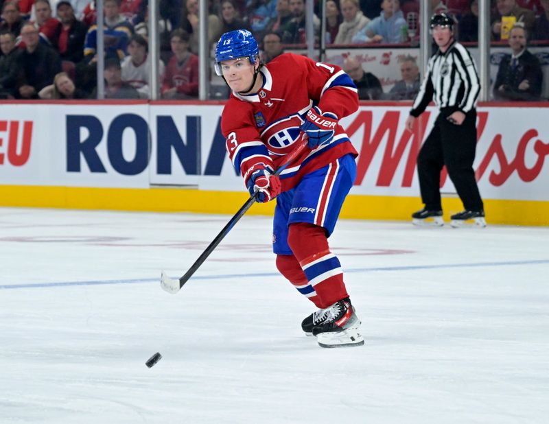 Oct 26, 2024; Montreal, Quebec, CAN; Montreal Canadiens forward Cole Caufield (13) passes the puck against the St.Louis Blues during the first period at the Bell Centre. Mandatory Credit: Eric Bolte-Imagn Images