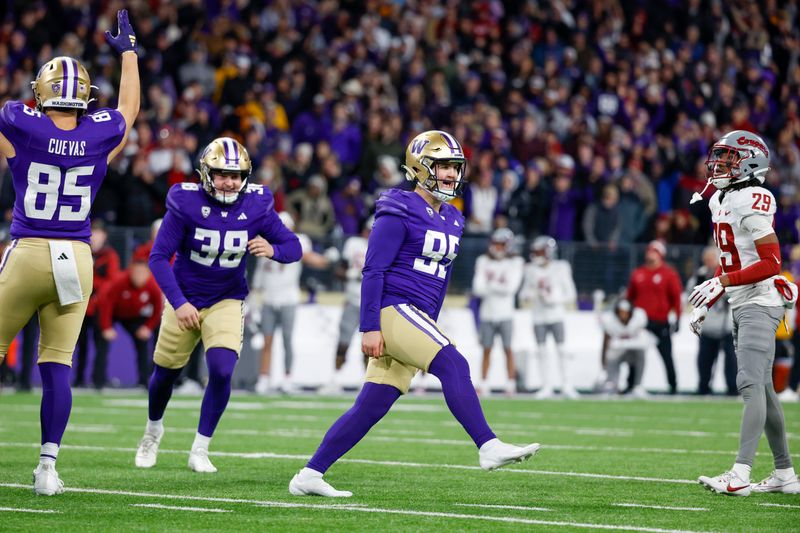 Nov 25, 2023; Seattle, Washington, USA; Washington Huskies place kicker Grady Gross (95) celebrates after making a game-winning field goal against the Washington State Cougars during the fourth quarter at Alaska Airlines Field at Husky Stadium. Washington defeated Washington State, 24-21. Washington State Cougars defensive back Jamorri Colson (29) reacts at right. Mandatory Credit: Joe Nicholson-USA TODAY Sports