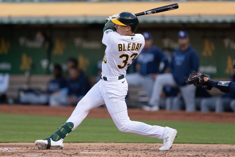 Jun 14, 2023; Oakland, California, USA;  Oakland Athletics left fielder JJ Bleday (33) hits a three-run home run during the second inning against the Tampa Bay Rays at Oakland-Alameda County Coliseum. Mandatory Credit: Stan Szeto-USA TODAY Sports