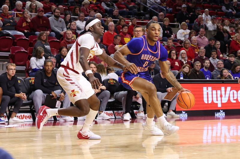 Dec 29, 2025; Ames, Iowa, USA; Iowa State Cyclones guard Killyan Toure (27) defends Houston Christian Huskies guard Demari Williams (0) during the second half at James H. Hilton Coliseum. Mandatory Credit: Reese Strickland-Imagn Images