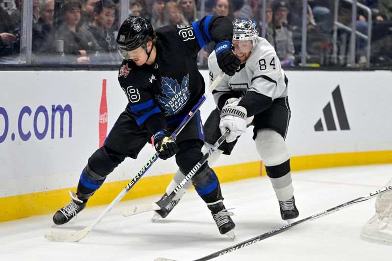 Jan 2, 2024; Los Angeles, California, USA; Toronto Maple Leafs right wing William Nylander (88) and Los Angeles Kings defenseman Vladislav Gavrikov (84) battle for the puck in the third period at Crypto.com Arena. Mandatory Credit: Jayne Kamin-Oncea-USA TODAY Sports