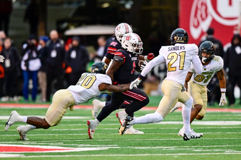 Nov 25, 2023; Salt Lake City, Utah, USA; Utah Utes running back Jaylon Glover (1) gets tackled by Colorado Buffaloes inside linebacker LaVonta Bentley (20) at Rice-Eccles Stadium. Mandatory Credit: Christopher Creveling-USA TODAY Sports