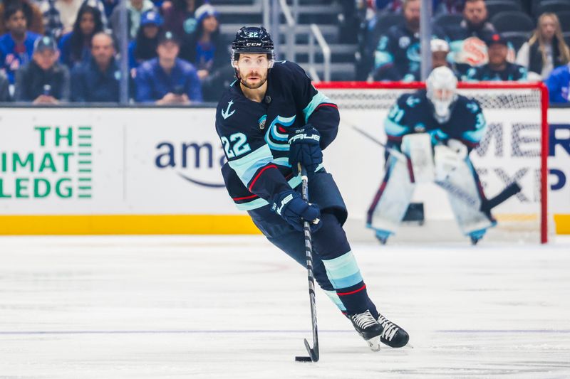 Nov 17, 2024; Seattle, Washington, USA; Seattle Kraken right wing Oliver Bjorkstrand (22) skates with the puck against the New York Rangers during the first period at Climate Pledge Arena. Mandatory Credit: Joe Nicholson-Imagn Images