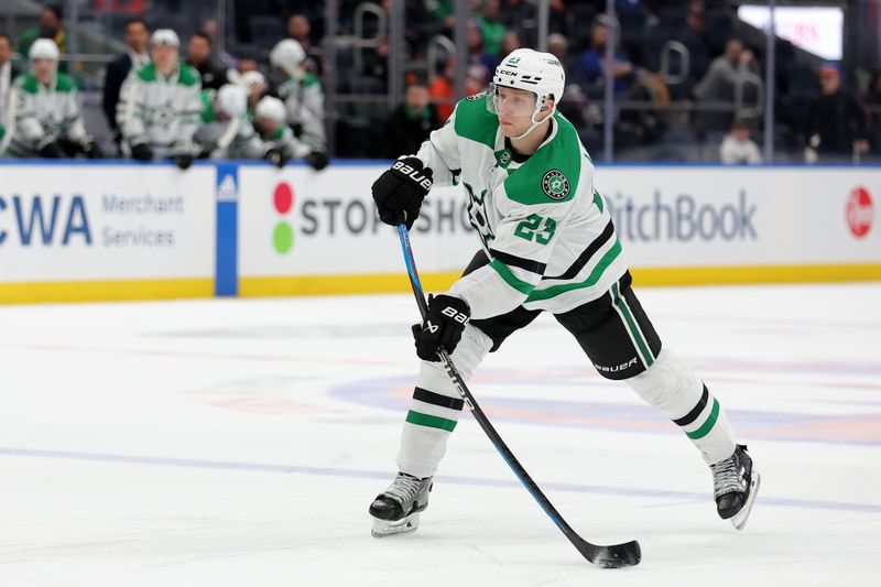 Jan 21, 2024; Elmont, New York, USA; Dallas Stars defenseman Esa Lindell (23) takes a shot against the New York Islanders during the third period at UBS Arena. Mandatory Credit: Brad Penner-USA TODAY Sports