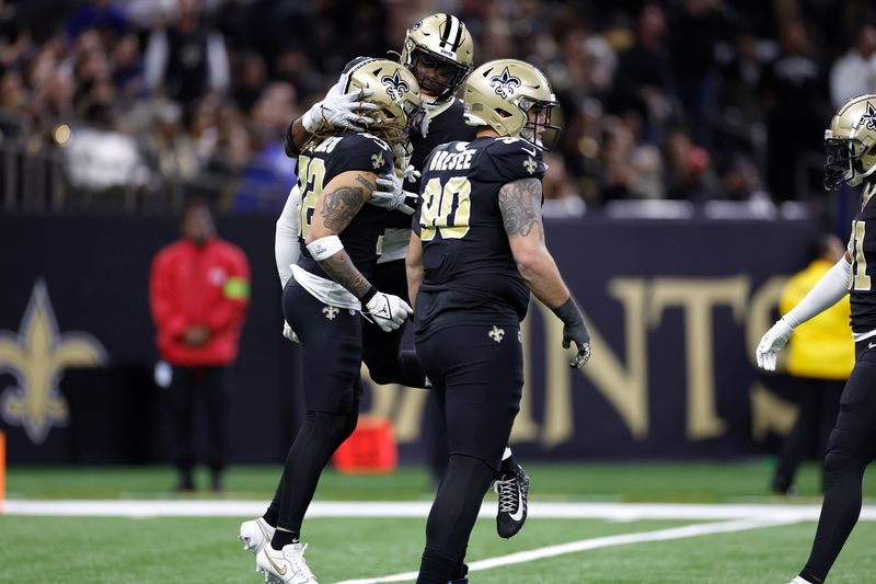 New Orleans Saints safety Ugo Amadi (0) celebrates after a play with safety Tyrann Mathieu (32) during an NFL football game against the Atlanta Falcons, Sunday, Jan. 7, 2024, in New Orleans. (AP Photo/Tyler Kaufman)