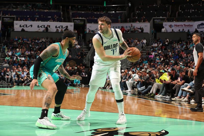 CHARLOTTE, NC - APRIL 9: Luka Doncic #77 of the Dallas Mavericks handles the ball against Miles Bridges #0 of the Charlotte Hornets during the game on April 9, 2024 at Spectrum Center in Charlotte, North Carolina. NOTE TO USER: User expressly acknowledges and agrees that, by downloading and or using this photograph, User is consenting to the terms and conditions of the Getty Images License Agreement. Mandatory Copyright Notice: Copyright 2024 NBAE (Photo by Kent Smith/NBAE via Getty Images)