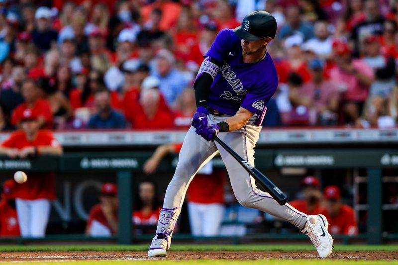 Jul 10, 2024; Cincinnati, Ohio, USA; Colorado Rockies outfielder Nolan Jones (22) hits a single against the Cincinnati Reds in the fourth inning at Great American Ball Park. Mandatory Credit: Katie Stratman-USA TODAY Sports