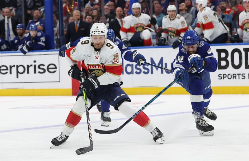 Apr 30, 2025; Tampa, Florida, USA; Florida Panthers center Sam Bennett (9) skates with the puck as Tampa Bay Lightning defenseman Erik Cernak (81) defends during the second period of game five of the first round of the 2025 Stanley Cup Playoffs at Amalie Arena. Mandatory Credit: Kim Klement Neitzel-Imagn Images