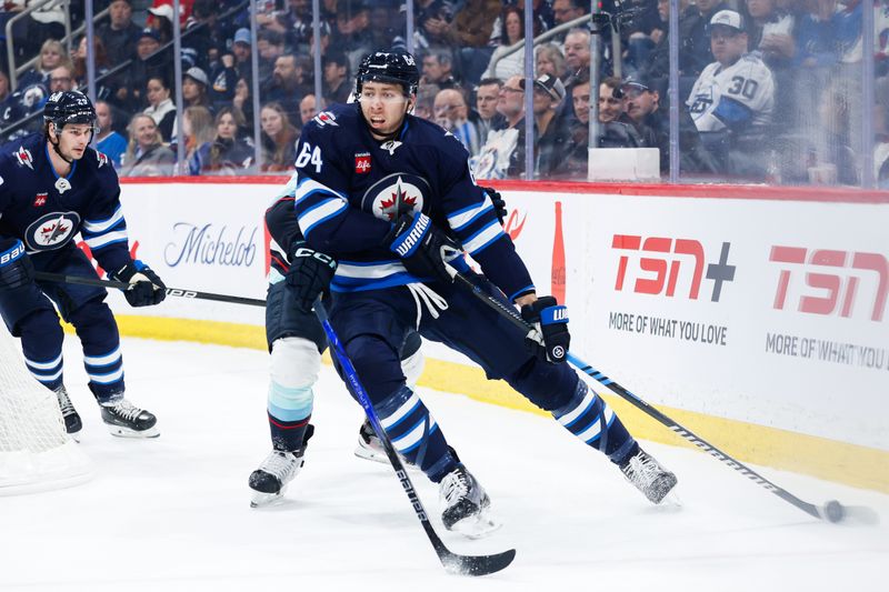 Apr 16, 2024; Winnipeg, Manitoba, CAN;  Winnipeg Jets defenseman Logan Stanley (64) skates away from Seattle Kraken forward Pierre-Edouard Bellemare (41) during the first period at Canada Life Centre. Mandatory Credit: Terrence Lee-USA TODAY Sports