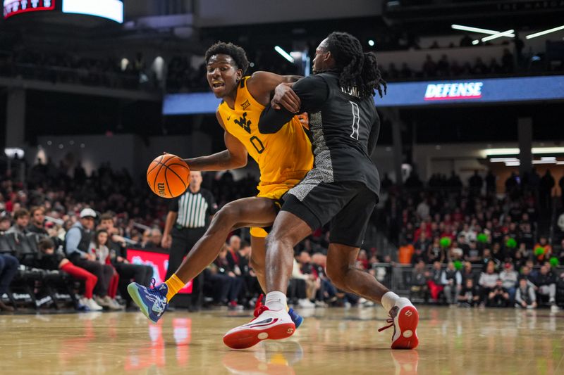 Feb 5, 2026; Cincinnati, Ohio, USA;  West Virginia Mountaineers forward Brenen Lorient (0) dribbles the ball against Cincinnati Bearcats guard Day Day Thomas (1) in the second half at Fifth Third Arena. Mandatory Credit: Aaron Doster-Imagn Images