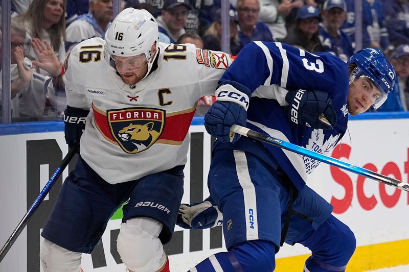 May 5, 2025; Toronto, Ontario, CAN; Toronto Maple Leafs forward Matthew Knies (23) and Florida Panthers forward Aleksander Barkov (16) battle for position during the first period of game one of the second round of the 2025 Stanley Cup Playoffs at Scotiabank Arena. Mandatory Credit: John E. Sokolowski-Imagn Images