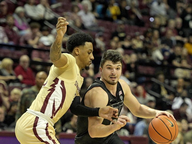 Jan 6, 2024; Tallahassee, Florida, USA; Virginia Tech Hokies guard Hunter Cattoor (0) drives to the net past Florida State Seminoles guard Primo Spears (23) during the second half at Donald L. Tucker Center. Mandatory Credit: Melina Myers-USA TODAY Sports