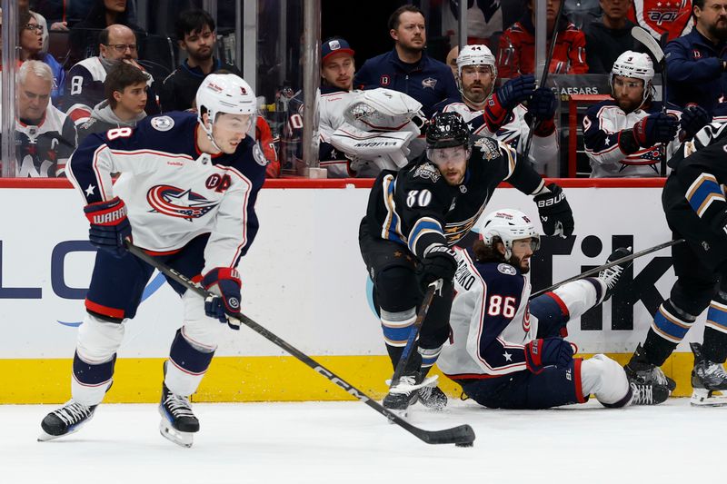 Apr 13, 2025; Washington, District of Columbia, USA; Columbus Blue Jackets defenseman Zach Werenski (8) and Washington Capitals left wing Pierre-Luc Dubois (80) battle for the puck in the first period at Capital One Arena. Mandatory Credit: Geoff Burke-Imagn Images