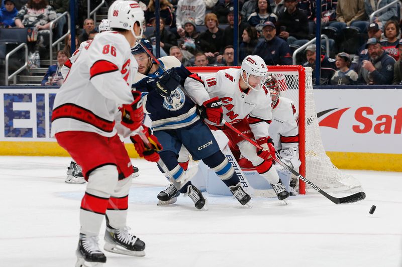 Feb 29, 2024; Columbus, Ohio, USA; Carolina Hurricanes center Jack Drury (18) clears a loose puck against the Columbus Blue Jackets] during the third period at Nationwide Arena. Mandatory Credit: Russell LaBounty-USA TODAY Sports