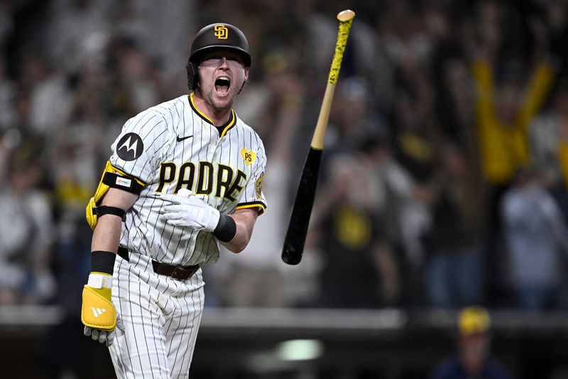 Jun 20, 2024; San Diego, California, USA; San Diego Padres second baseman Jake Cronenworth (9) tosses his bat after hitting a walk-off home run during the ninth inning against the Milwaukee Brewers at Petco Park. Mandatory Credit: Orlando Ramirez-USA TODAY Sports