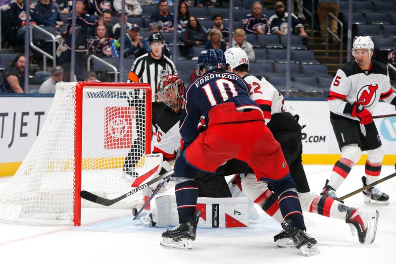 Oct 13, 2025; Columbus, Ohio, USA; Columbus Blue Jackets left wing Dmitri Voronkov (10) tips the puck past New Jersey Devils goalie Jacob Markstrom (25) for a goal during the third period at Nationwide Arena. Mandatory Credit: Russell LaBounty-Imagn Images