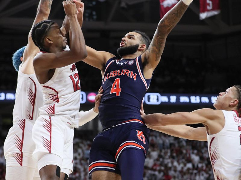 Jan 6, 2024; Fayetteville, Arkansas, USA; Auburn Tigers forward Johni Broome (4) shoots in the first half as Arkansas Razorbacks guard Truman Mark (12) defends at Bud Walton Arena. Mandatory Credit: Nelson Chenault-USA TODAY Sports