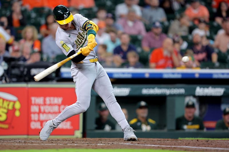 May 28, 2025; Houston, Texas, USA;  Athletics designated hitter Brent Rooker (25) hits an RBI double to left field against the Houston Astros during the third inning at Daikin Park. Mandatory Credit: Erik Williams-Imagn Images