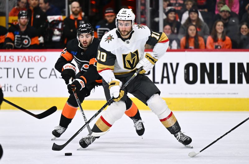 Nov 18, 2023; Philadelphia, Pennsylvania, USA; Vegas Golden Knights center Nicolas Roy (10) controls the puck against Philadelphia Flyers left wing Noah Cates (27) in the first period at Wells Fargo Center. Mandatory Credit: Kyle Ross-USA TODAY Sports