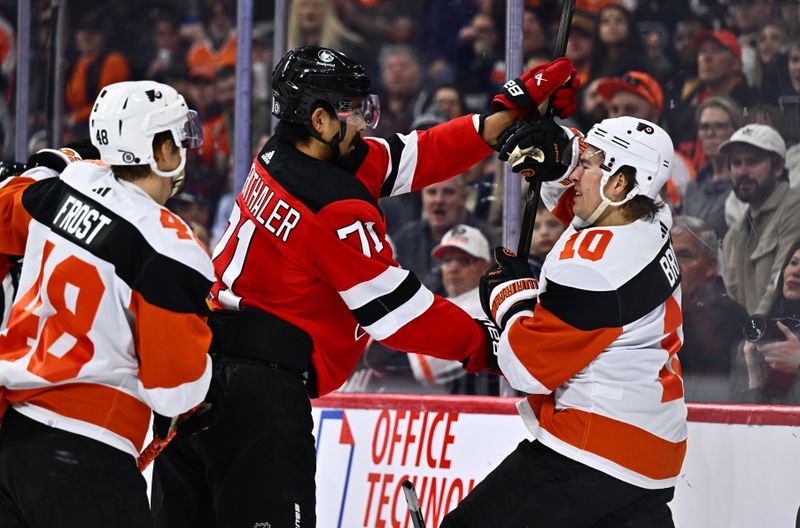 Apr 13, 2024; Philadelphia, Pennsylvania, USA; New Jersey Devils defenseman Jonas Siegenthaler (71) hits Philadelphia Flyers right wing Bobby Brink (10) in the first period at Wells Fargo Center. Mandatory Credit: Kyle Ross-USA TODAY Sports