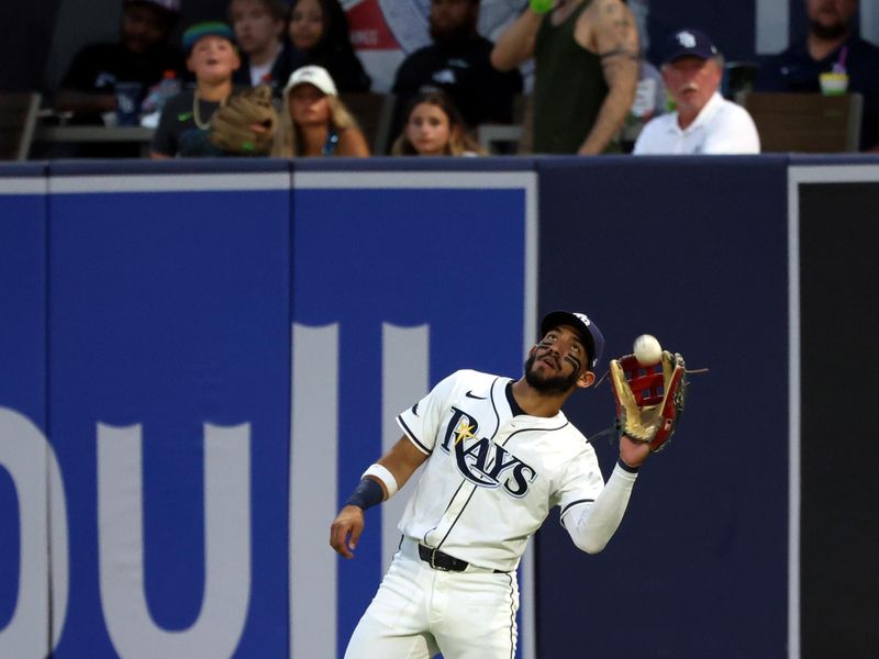 Jun 30, 2025; Tampa, Florida, USA; Tampa Bay Rays outfielder Jose Caballero (77) catches a fly ball against the Athletics during the fourth inning at George M. Steinbrenner Field. Mandatory Credit: Kim Klement Neitzel-Imagn Images