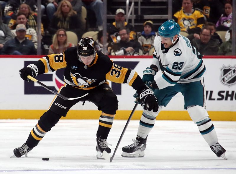 Nov 16, 2024; Pittsburgh, Pennsylvania, USA;  Pittsburgh Penguins defenseman Owen Pickering (38) moves the puck against  San Jose Sharks right wing Barclay Goodrow (23) during the third period at PPG Paints Arena. Mandatory Credit: Charles LeClaire-Imagn Images