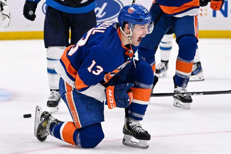 Mar 23, 2024; Elmont, New York, USA;  New York Islanders center Mathew Barzal (13) celebrates his goal against the Winnipeg Jets during the second period at UBS Arena. Mandatory Credit: Dennis Schneidler-USA TODAY Sports