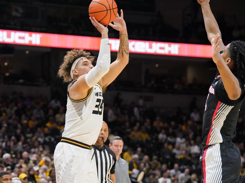 Jan 6, 2024; Columbia, Missouri, USA; Missouri Tigers forward Noah Carter (35) shoots a three point shot as Georgia Bulldogs guard Silas Demary Jr. (4) defends during the first half at Mizzou Arena. Mandatory Credit: Denny Medley-USA TODAY Sports