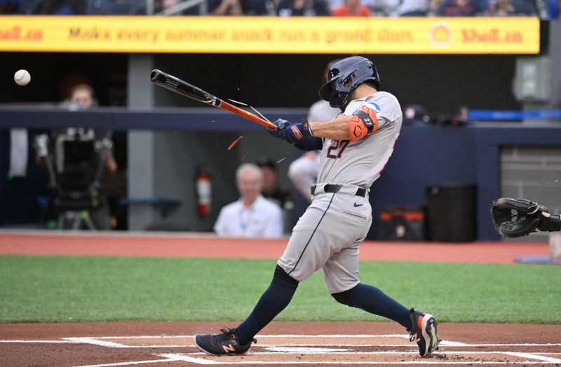 Jul 2, 2024; Toronto, Ontario, CAN;   Houston Astros second baseman Jose Altuve (27) breaks his bat as he hits a single against the Toronto Blue Jays in the first inning at Rogers Centre. Mandatory Credit: Dan Hamilton-USA TODAY Sports