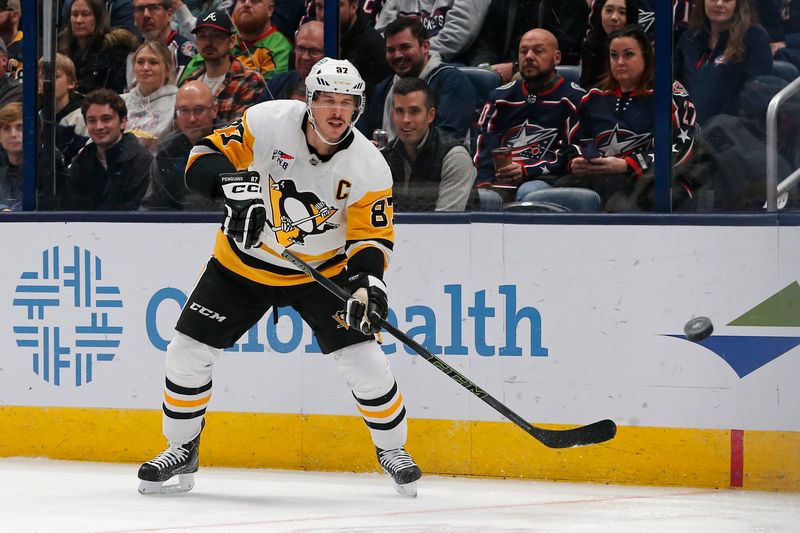 Nov 15, 2024; Columbus, Ohio, USA; Pittsburgh Penguins center Sidney Crosby (87) passes the puck against the Columbus Blue Jackets during the second period at Nationwide Arena. Mandatory Credit: Russell LaBounty-Imagn Images