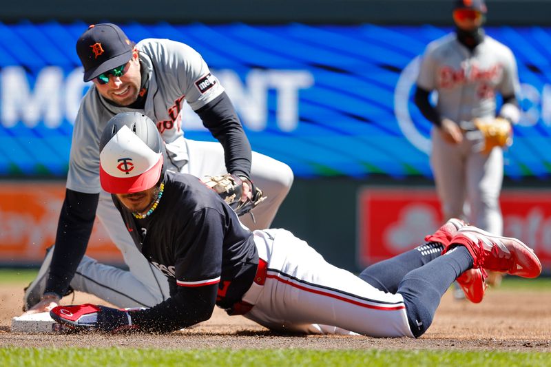 Apr 20, 2024; Minneapolis, Minnesota, USA; Minnesota Twins left fielder Austin Martin (82) dives back into third base on a pickoff attempt by Detroit Tigers third baseman Matt Vierling (8) in the third inning at Target Field. Mandatory Credit: Bruce Kluckhohn-USA TODAY Sports