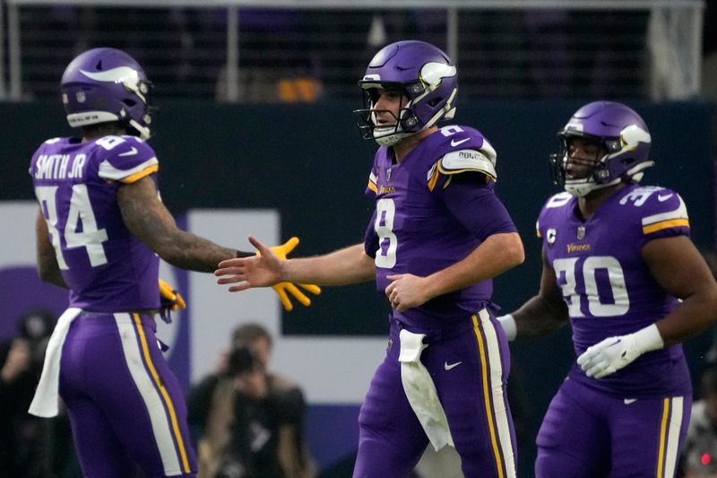 Minnesota Vikings quarterback Kirk Cousins (8) runs off the field during the first half of an NFL wild card playoff football game against the New York Giants, Sunday, Jan. 15, 2023, in Minneapolis. (AP Photo/Charlie Neibergall)