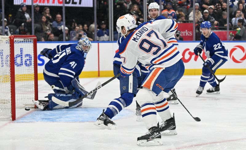 Nov 16, 2024; Toronto, Ontario, CAN;   Edmonton Oilers forward Connor McDavid (97) scores a goal against Toronto Maple Leafs goalie Anthony Stolarz (41) in the second period at Scotiabank Arena. Mandatory Credit: Dan Hamilton-Imagn Images